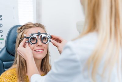 oculist-and-young-patient-with-trial-frame-in-clinic.jpg